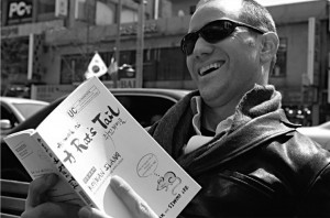 Peter Liptak on the streets of Itaewon reading A Rat's Tail